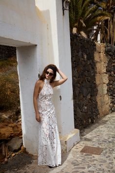 An elegant staple in your timeless vacation wardrobe—the Astoria white maxi dress is crafted in beautiful floral lace with striking scalloped edges.Cut on the bias, this ultra-flattering embroidered dress features a high-neck collar and contoured v-shaped waist team. White Lace Midi Dress For Gala, White Lace Midi Dress For Gala Events, Sleeveless Summer Lace Gala Dress, Sleeveless Lace Dress For Summer Gala, Spring Gala Lace Dress With Delicate Lace, Chic Lace Maxi Dress For Gala, Delicate Lace Dress For Spring Gala, Spring Gala Lace Dress With Lace Trim, Fitted Maxi Dress With Scalloped Lace For Summer