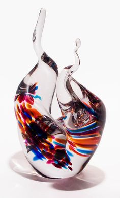 an artistic glass sculpture sitting on top of a table