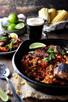 one pot mexican chicken and rice is served with lime wedges on the side for garnish