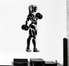 a black and white wall decal of a woman with dumbbells