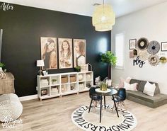 a living room filled with furniture and pictures on the wall