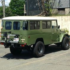 an army green jeep parked in a parking lot