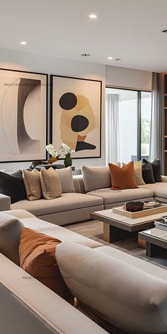 a living room filled with lots of couches and tables in front of large windows