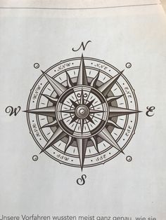 an image of a compass on paper with some writing in the middle and bottom corner