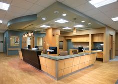 an empty office with wood flooring and lighting