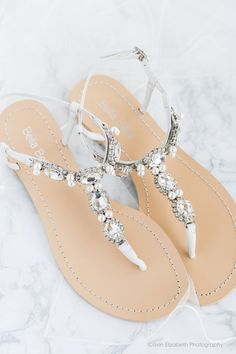 - Hera - Thong sandal - Rows of sparkling oval cut sparkles and pearls - Pictures do not do them justice - Lightest blue outsole for your 'something blue' - Off white leather strap - Adjustable buckle closure - Genuine leather upper - Genuine leather sole - Perfect for all occassion; beach weddings, destination weddings, outdoor weddings, reception, or the dance floor - Re-wear them after your special day - perfect for summer nights out - Sizing runs true to size Silver Bridal Sandals, Cowgirl Boots Wedding, Sandal Tali, Wedding Shoes Sandals, Pearl Wedding Shoes, Cowgirl Wedding, Beach Wedding Shoes, Wedding Shoes Comfortable, Wedding Boots