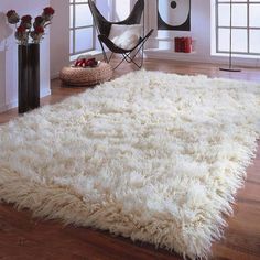 a large white rug in a living room