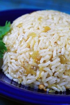 a blue plate topped with rice and garnished with parsley