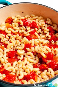 a pot filled with pasta and sauce on top of a stove