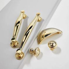 gold door handles and knobs on a white surface