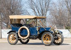 an old blue car is parked in the parking lot