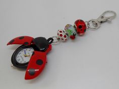 This is a super cute ladybird bagcharm watch.  The wings open up to reveal the watch face.  One of the the beads is a lampwork glass bead with ladybirds on and the other is a red bead with black spots. The bottom bead is a silver plated crystal diamante with red crystals. Family Baking, Fob Watch, Pocket Watches, Cute Keychain, Purse Accessories, Lampwork Glass Beads, Red Crystals, Red Bead, Cool Items