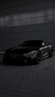 a black sports car parked in front of a building