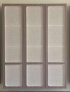 a room divider made out of wood with mesh panels on the doors and bottom