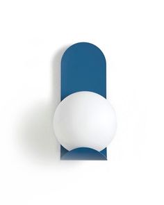 a blue and white wall light on a white wall with an oval shaped bulb in the middle