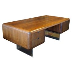 a wooden desk with two drawers on each side and one drawer at the end,