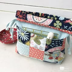 the zippered pouch is made from patchwork fabric and has an inner pocket to hold it