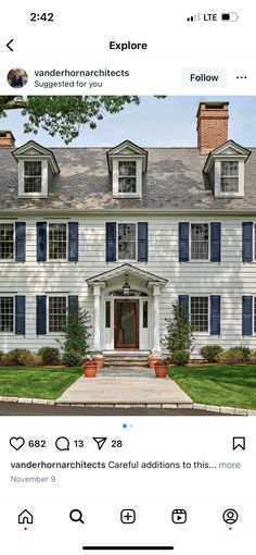 an image of a white house with blue shutters on the front and side windows