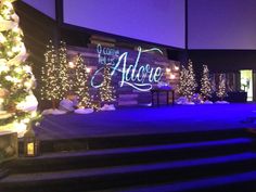 the stage is decorated with christmas trees and lights