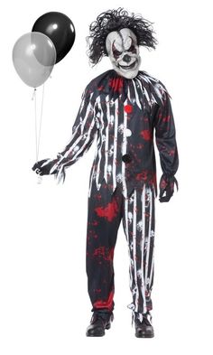 a man in a clown costume holding a black and silver balloon with white paint on it