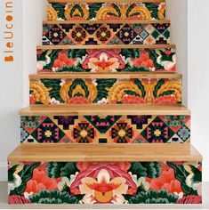 an artistic stair case with colorful flowers and leaves on the bottom, painted in bright colors