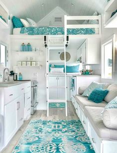 a loft bed is in the middle of a room with white walls and blue rugs