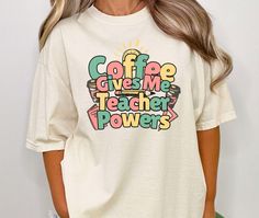 a woman wearing a t - shirt that says coffee gives me teacher powers on it