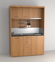 an empty kitchen with wooden cabinets and black counter tops, is shown in front of a white wall