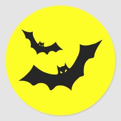 two bats flying in the sky on a yellow background round sticker with black outline