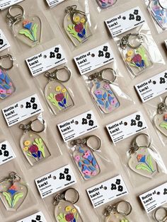 many different key chains with flowers on them