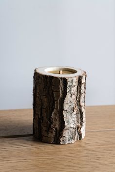 a wooden candle holder sitting on top of a table