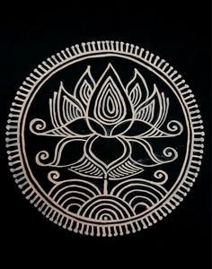 a white and black circular design on a black background with an intricate flower in the center