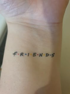 a wrist tattoo with the word friends written in small letters on it's side