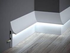 an empty room with wood flooring and white lighting