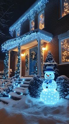 a lighted snowman in front of a house