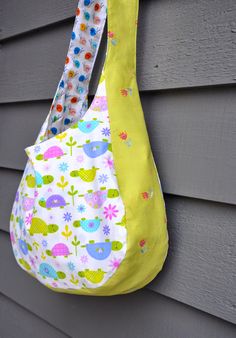 a handbag hanging on the side of a house with flowers and birds all over it