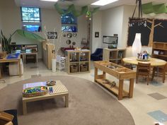 a room filled with lots of wooden tables and chairs