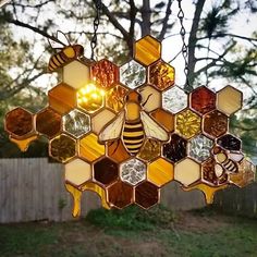 a stained glass honeycomb hanging from a chain