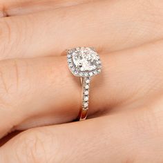 a woman's hand with a diamond ring on it