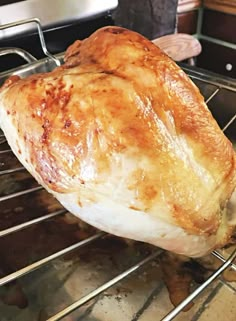 a piece of chicken sitting on top of an oven rack