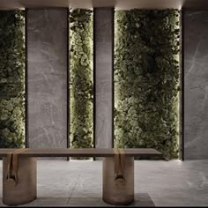 an elegant dining table in front of two vertical green plants on the wall behind it