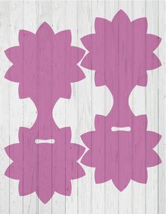 two pink flowers are on a white wood background