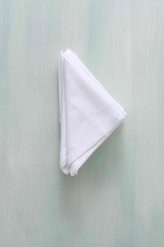 a folded white napkin sitting on top of a table