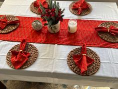 the table is set with red napkins and place settings