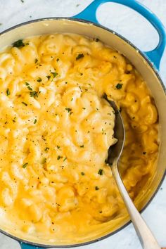 macaroni and cheese in a blue pot with a spoon