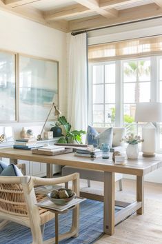 a living room filled with lots of furniture and decor on top of a blue rug