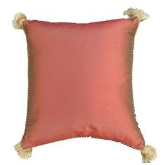 a red pillow with tassels on it