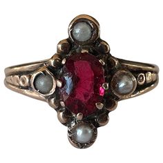 Crafted in the late nineteenth century, this antique navette shaped dinner ring is designed around an oval red garnet and accented by four seed pearls. Set in 10K rose gold. Antique Victorian Engagement Rings, Garnet And Diamond Engagement Ring, Dark Red Jewelry, Vintage Ruby Rings, Vintage Garnet Rings, Indian Engagement Ring, Ruby Ring Vintage, Dinner Ring, Seed Pearl Ring