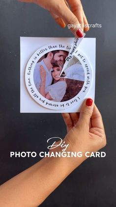 two hands holding up a card with an image of a man and woman on it