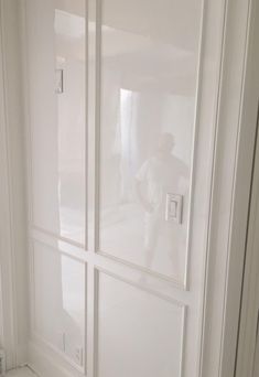 a white closet with glass doors and drawers